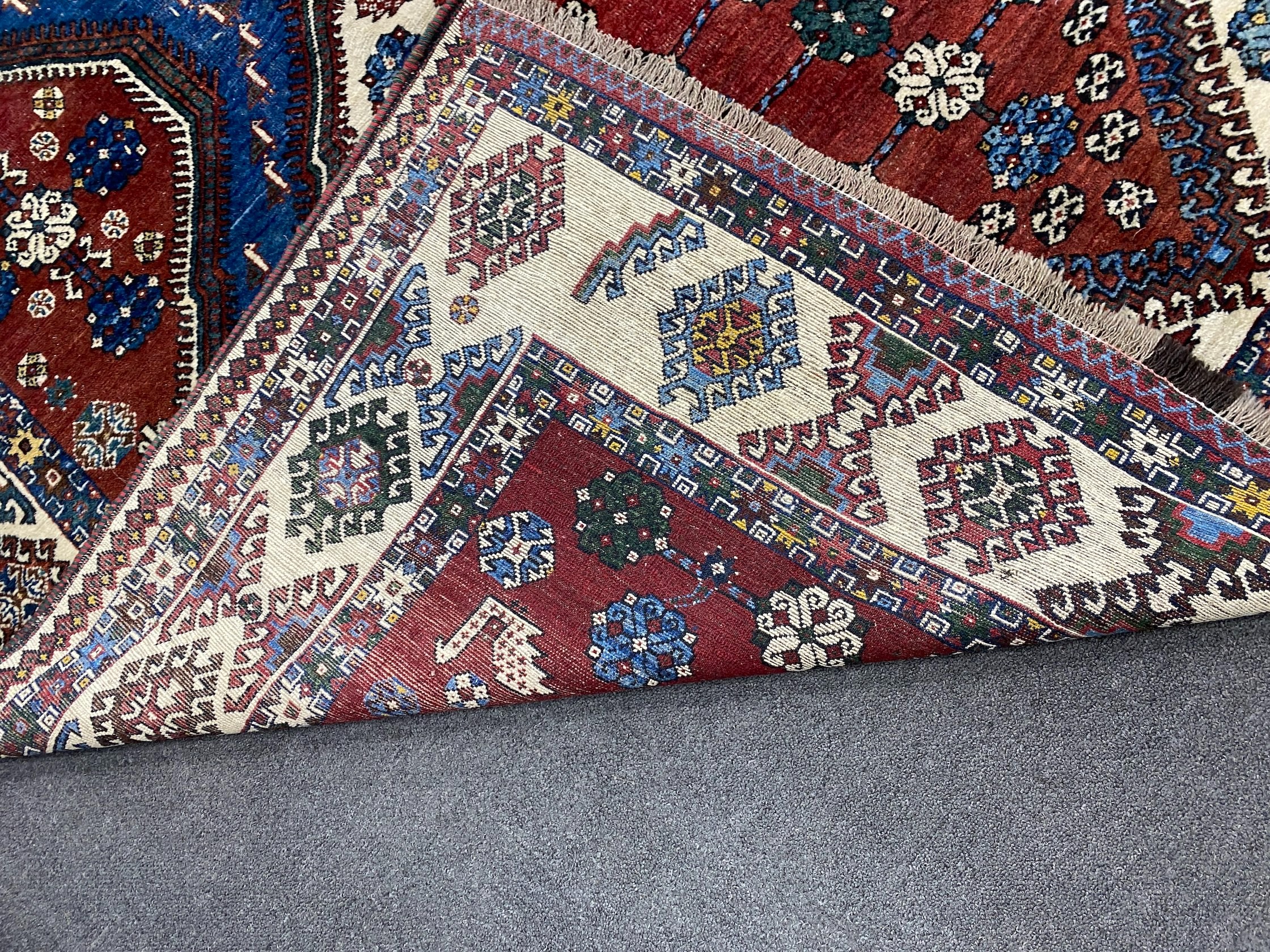 A Caucasian red ground carpet, 335 x 214cm